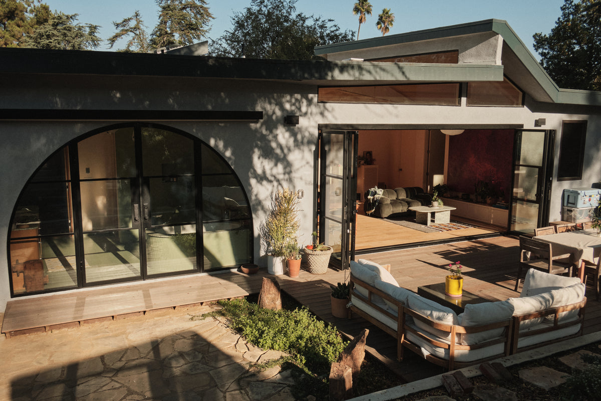 wide shot of steel double arch top doors and steel center split bi-fold in luxury home