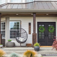 Double door made of iron and steel with a thick frame, a 12-pane window on each side and a solid bottom. Door is thermally broken to protect from extreme weather.
