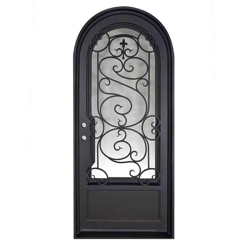 Single entryway door with a thick iron and steel frame, a window behind intricate iron patterning, a full arch, and a solid bottom. Door is thermally broken to protect from extreme weather.