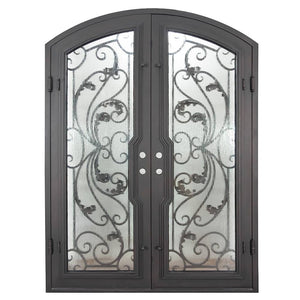 Double doors for an entryway made with a thick iron and steel frame, a slight arch at the top, and full paneled windows behind an intricate iron design. Doors are thermally broken to protect from extreme weather.