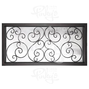 Large rectangular transom window behind an intricate iron pattern. Window is thermally broken to protect from extreme weather.