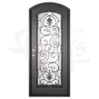 Single entryway door with full length pane of glass behind intricate iron detailing. Door features a slight arch and is thermally broken to protect from extreme weather.