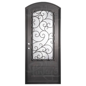 Single entryway door with a 3/4 length pane of glass behind intricate iron detailing. Door features a slight arch and is thermally broken to protect from extreme weather.