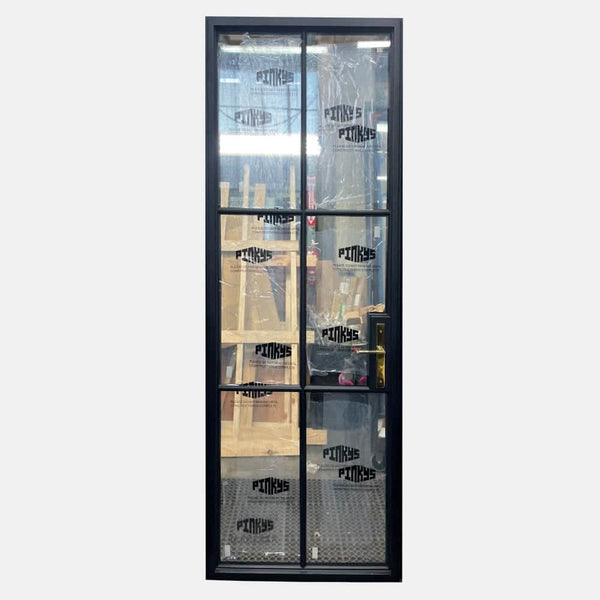 Single steel door with grids and polished brass lockset.